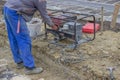 Construction Worker starts the portable Electric Generator 2