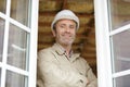 construction worker stood at open windows Royalty Free Stock Photo