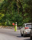 A construction worker stopping traffic, holding a stop sign