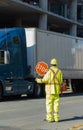 A construction worker stopping traffic, holding a stop sign