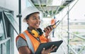 Construction worker with tablet, walkie talkie or radio talking, instructing and checking building progress on Royalty Free Stock Photo