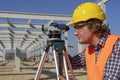 Construction Worker With Tacheometer on Site Under Construction