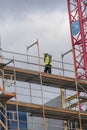 Construction worker talking on phone on scaffolding