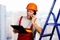 Construction worker talking on smartphone. Royalty Free Stock Photo