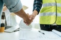 Construction worker team contractor handshake after finishing business meeting to start up project contract in construction site b Royalty Free Stock Photo