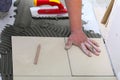 Construction worker is tiling at home, tile floor adhesive Royalty Free Stock Photo