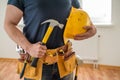 Construction worker with tool belt and hammer Royalty Free Stock Photo