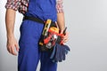 Construction worker with tool belt on light background, closeup Royalty Free Stock Photo