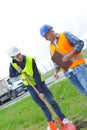 Construction worker trainee digging with shovel