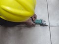 A construction worker uses an angle grinder to score the concrete floor. Creating a tile pattern on the surface Royalty Free Stock Photo