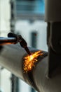 Construction worker using blowtorch welding metal pipe on construction site Royalty Free Stock Photo