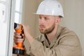 construction worker using drill to install replacement window Royalty Free Stock Photo