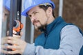 Construction worker using drill to install window Royalty Free Stock Photo