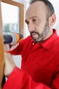 construction worker using drill to install window Royalty Free Stock Photo