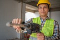 Construction worker Using an electric jackhammer to drill perforator equipment making holes before pouring the floor to be strong Royalty Free Stock Photo