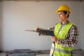 Construction worker Using an electric jackhammer to drill perforator equipment making holes before pouring the floor to be strong Royalty Free Stock Photo