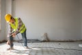 Construction worker Using an electric jackhammer to drill perforator equipment making holes before pouring the floor to be strong Royalty Free Stock Photo