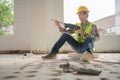 Construction worker Using an electric jackhammer to drill perforator equipment making holes before pouring the floor to be strong Royalty Free Stock Photo