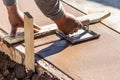 Worker Using Hand Groover On Wet Cement Forming Coping Around New Pool Royalty Free Stock Photo