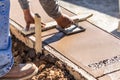 Construction Worker Using Hand Groover On Wet Cement Forming Coping Around New Pool Royalty Free Stock Photo