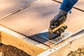 Construction Worker Using Hand Groover On Wet Cement Forming Coping Around New Pool Royalty Free Stock Photo