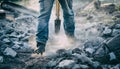 Construction Worker Using Jackhammer on Demolition Site with Dust Royalty Free Stock Photo