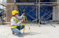A construction worker is using a laser gauge to capture the setting of masonry, plastering and wall work at a building site Royalty Free Stock Photo