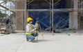 A construction worker is using a laser gauge to capture the setting of masonry, plastering and wall work at a building site Royalty Free Stock Photo