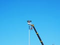 Construction worker using lifting boom on blue sky Royalty Free Stock Photo