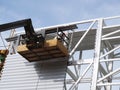 Construction worker using lifting boom Royalty Free Stock Photo