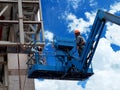 Construction worker using lifting boom Royalty Free Stock Photo