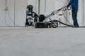 Construction worker using machine polishing surface floor smoothing and finishing hardener or epoxy concrete in the factory Royalty Free Stock Photo