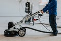 Construction worker using machine polishing surface floor smoothing and finishing hardener or epoxy concrete in the factory Royalty Free Stock Photo