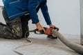 Construction worker using machine polishing surface floor smoothing and finishing hardener or epoxy concrete in the factory Royalty Free Stock Photo