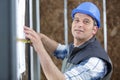 construction worker using measuring tape in new house Royalty Free Stock Photo