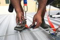 Construction worker using safety shock absorber lanyard with fall arrest, fall restraint harness protection device Royalty Free Stock Photo