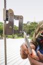 Construction worker using safety shock absorber lanyard with fall arrest, fall restraint harness protection device