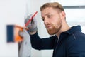 construction worker using spirit level and pencil Royalty Free Stock Photo