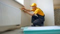 Construction worker using spirit level and pencil. Royalty Free Stock Photo