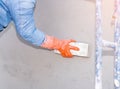 Construction worker are using sponge and plastering trowel to smooth the walls Royalty Free Stock Photo