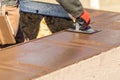 Construction Worker Using Stainless Steel Edger On Wet Cement Forming Coping Around New Pool