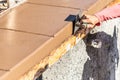 Construction Worker Using Stainless Steel Edger On Wet Cement Forming Coping Around New Pool Royalty Free Stock Photo