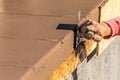 Construction Worker Using Stainless Steel Edger On Wet Cement Forming Coping Around New Pool Royalty Free Stock Photo