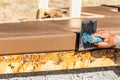 Construction Worker Using Stainless Steel Edger On Wet Cement Forming Coping Around New Pool