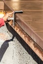 Construction Worker Using Stainless Steel Edger On Wet Cement Forming Coping Around New Pool Royalty Free Stock Photo