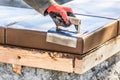 Construction Worker Using Stainless Steel Edger On Wet Cement Forming Coping Around New Pool