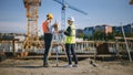 Construction Worker Using Theodolite Surveying Optical Instrument for Measuring Angles in Horizont Royalty Free Stock Photo