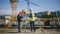 Construction Worker Using Theodolite Surveying Optical Instrument for Measuring Angles in Horizont Royalty Free Stock Photo