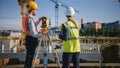 Construction Worker Using Theodolite Surveying Optical Instrument for Measuring Angles in Horizont Royalty Free Stock Photo