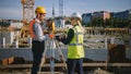 Construction Worker Using Theodolite Surveying Optical Instrument for Measuring Angles in Horizont Royalty Free Stock Photo